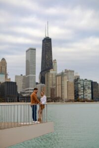 Couple Taking Engagement Photos With Skyline