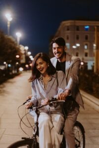 Couple Riding Bikes Together During Engagement Photos