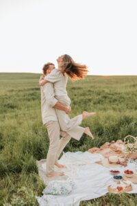 Picnic Engagement Photo theme in a Field During Golden Hour