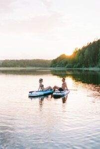 Couple Paddleboarding During Engagment Photos