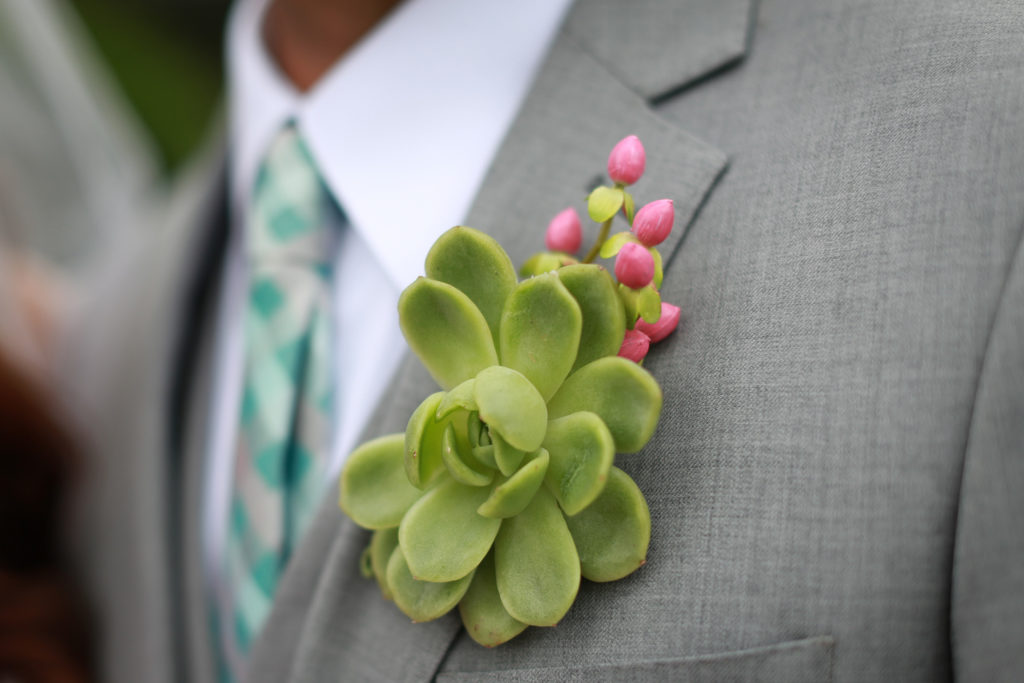 SEG_Green Succulent Boutonniere on Groom wearing gray suit