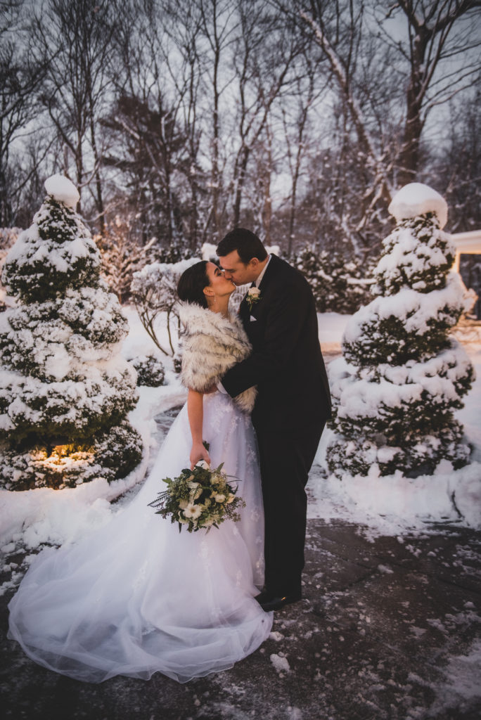 Saphire Estate | Couple Kissing at a Snowy Winter Wedding