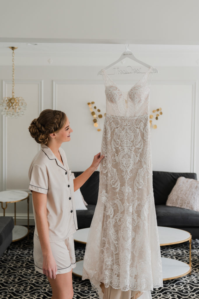 Saphire Estate | Bride Looking at Dress in Saphire Estate Bridal Suite