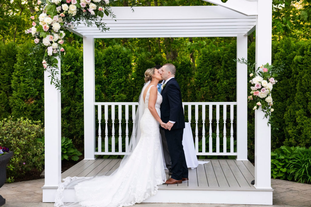 bride and groom kissing during ceremony