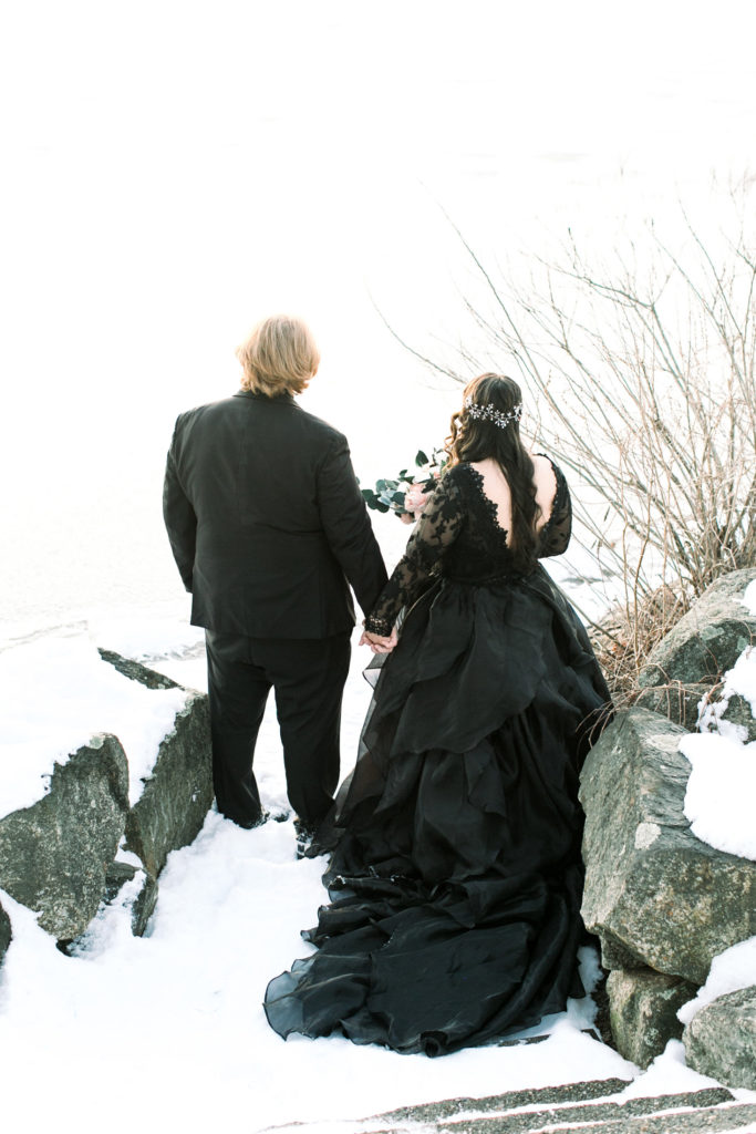 bride and groom looking at lake
