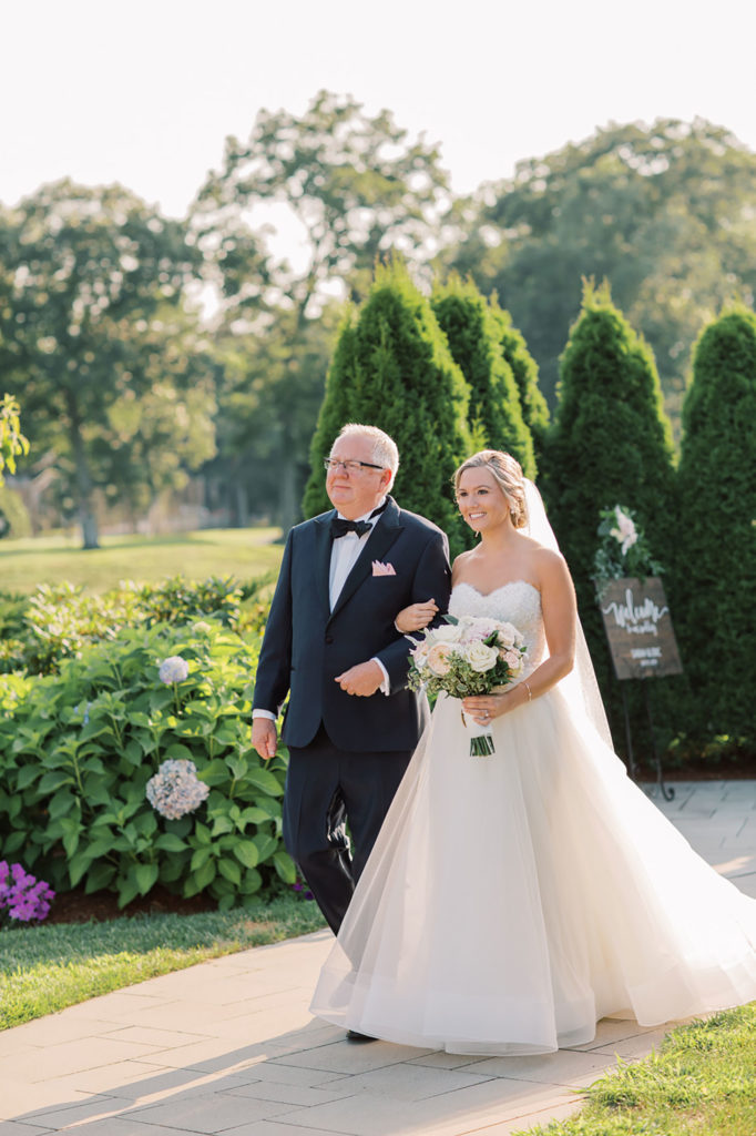 bride walking down aisle with dad