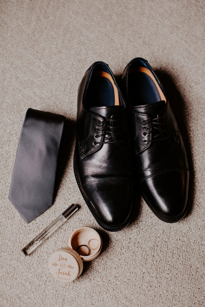 groom's shoes, tie, and ring box