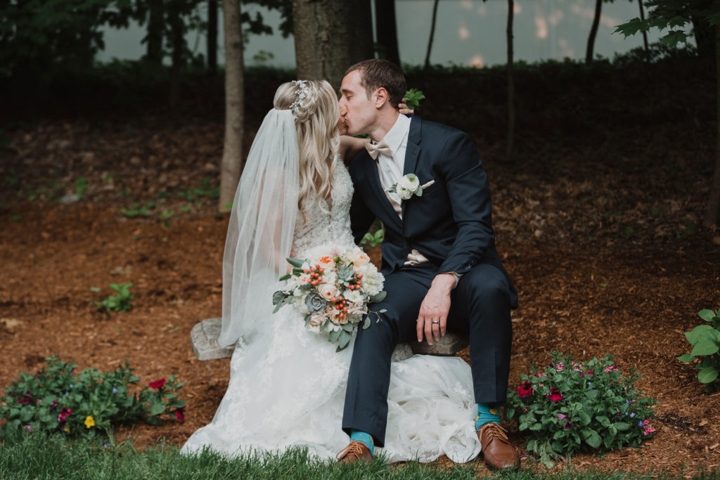 bride and groom kissing in garden