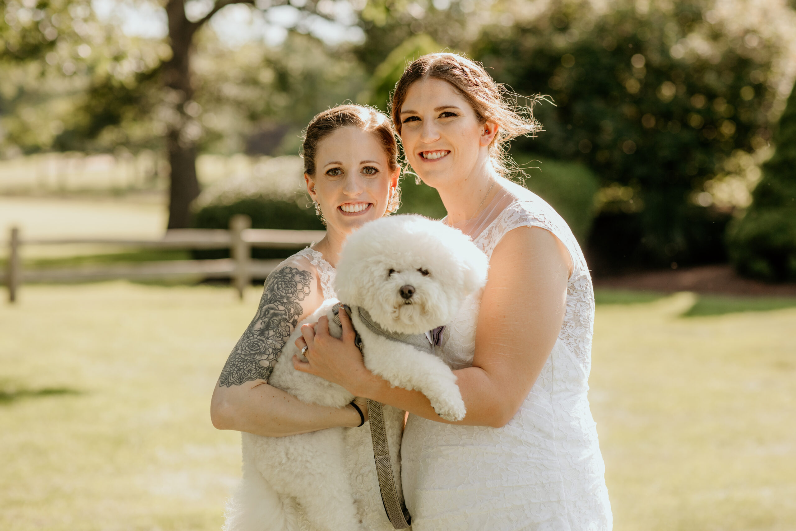 Brides Holding Their Dog on Their Wedding Day