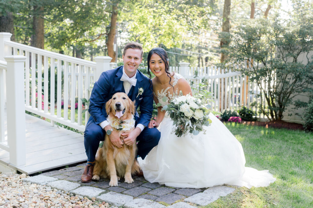Bride and Groom with Their Dog on Their Wedding Day