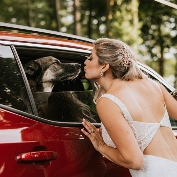 bride kisses dog in car
