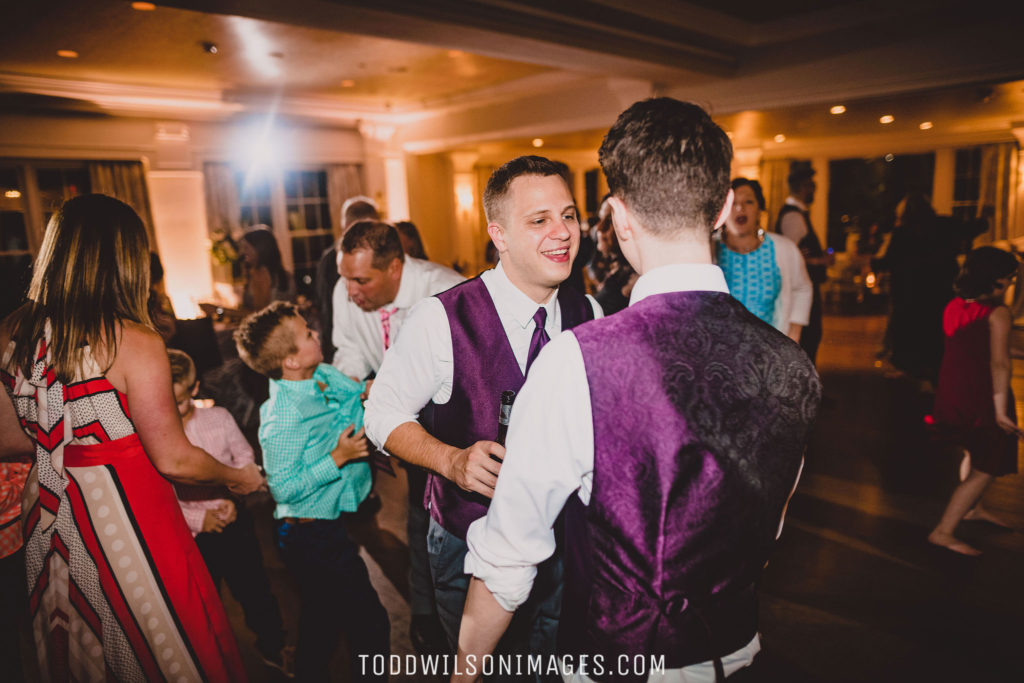 Grooms dancing during reception