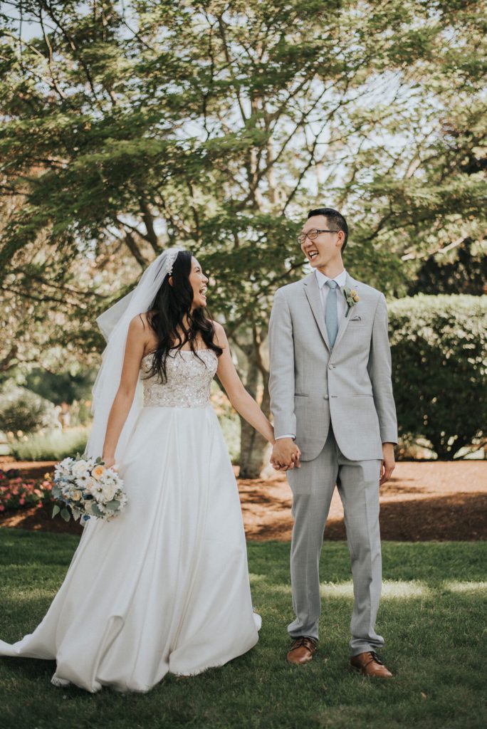 the-villa-grand-ballroom-july-wedding-cherry-and-dan-holding-hands