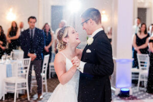 Bride and Groom Dancing in Ballroom With Fake Snow 
