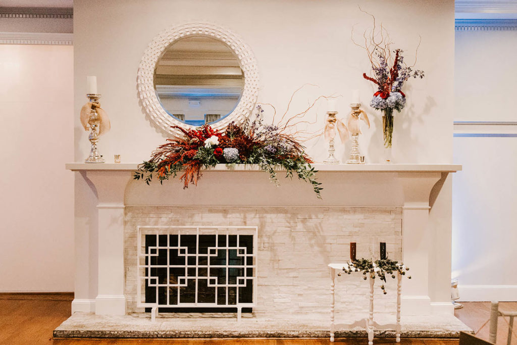 fall wedding decor on fireplace at Saphire Estate