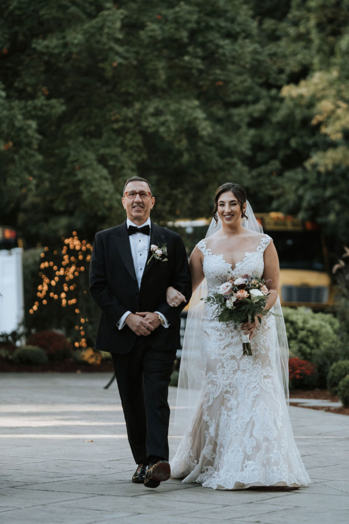 bride and father of bride walking down aisle