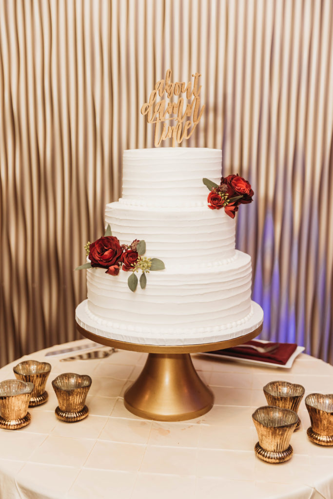 White 3 Tier Wedding Cake with Red Flowers