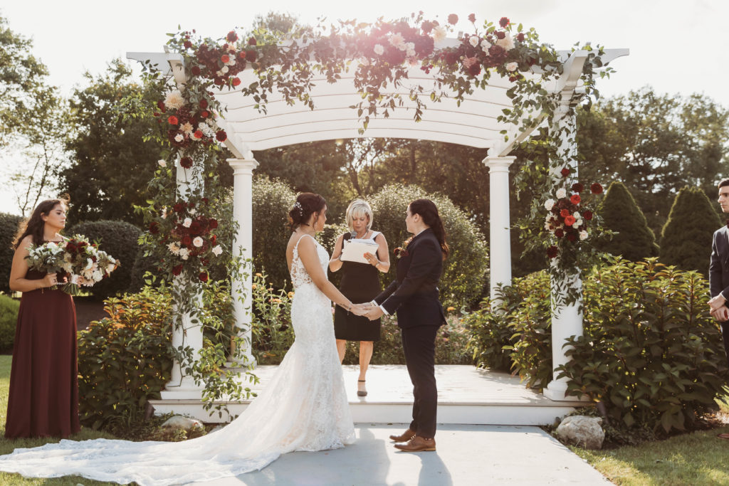 Outdoor Wedding Ceremony in front of Pergola at The Villa