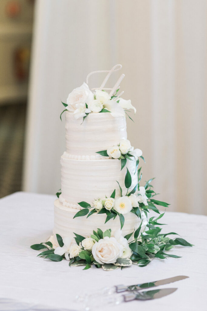 White Three Tiered Wedding Cake with White Flowers