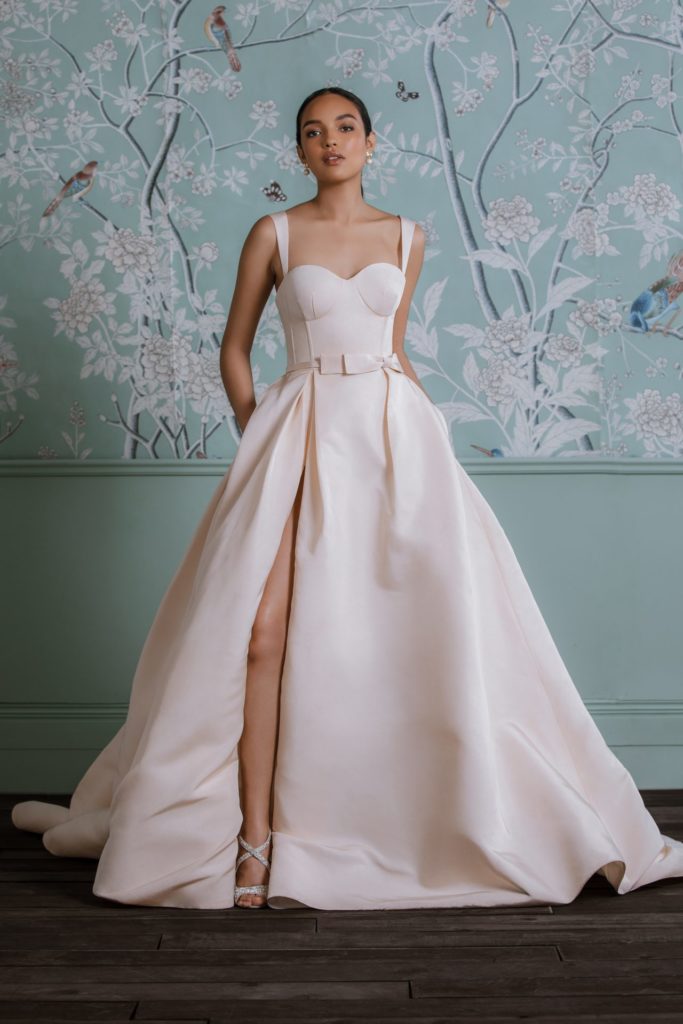 Bride modeling a 2023 Anne Barge wedding design with blush pink color