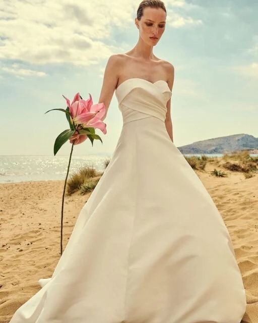 Bride modeling a 2023 Costarellos wedding dress with clean sleek lines