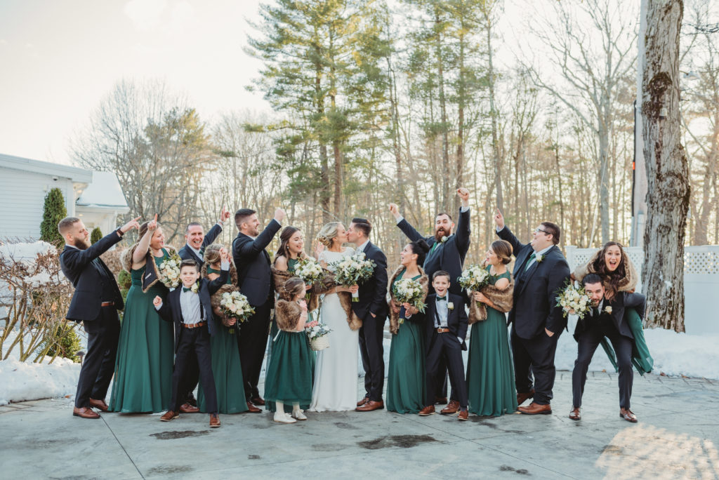 Wedding Party Cheering on Couple Kissing Winter Wedding Green Emerald Bridesmaids Dresses