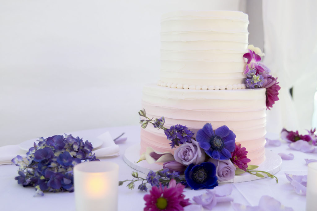 White Wedding Cake with Purple and Periwinkle Flowers