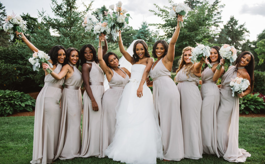 Wedding Party Pose of Bridesmaids Holding Up Bouquet