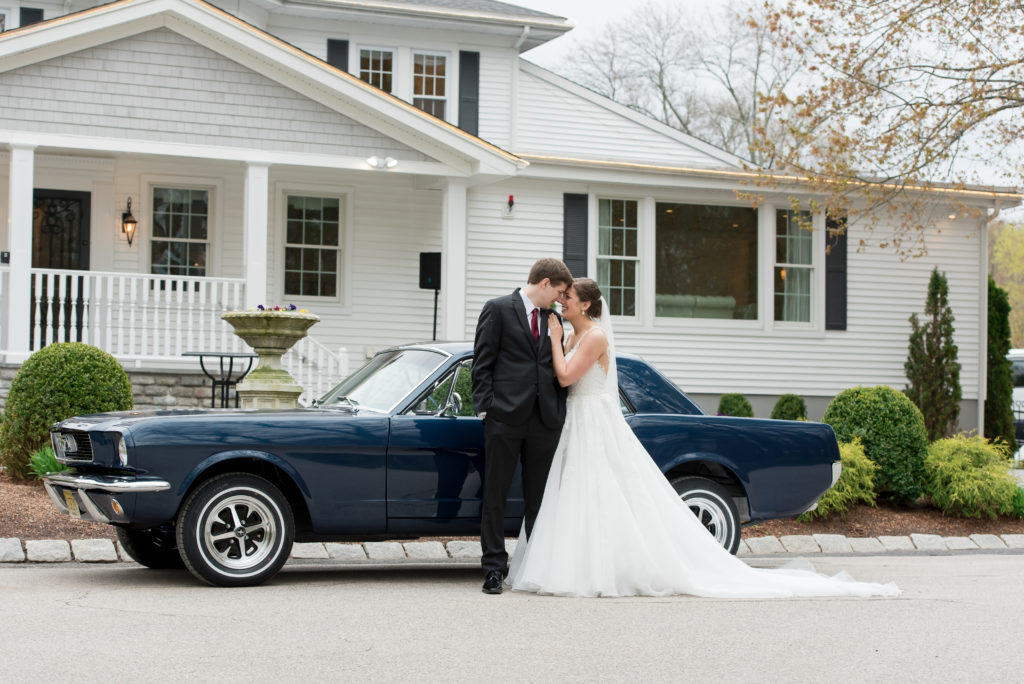 Bride and Groom Kiss Next to Vintage Mustang