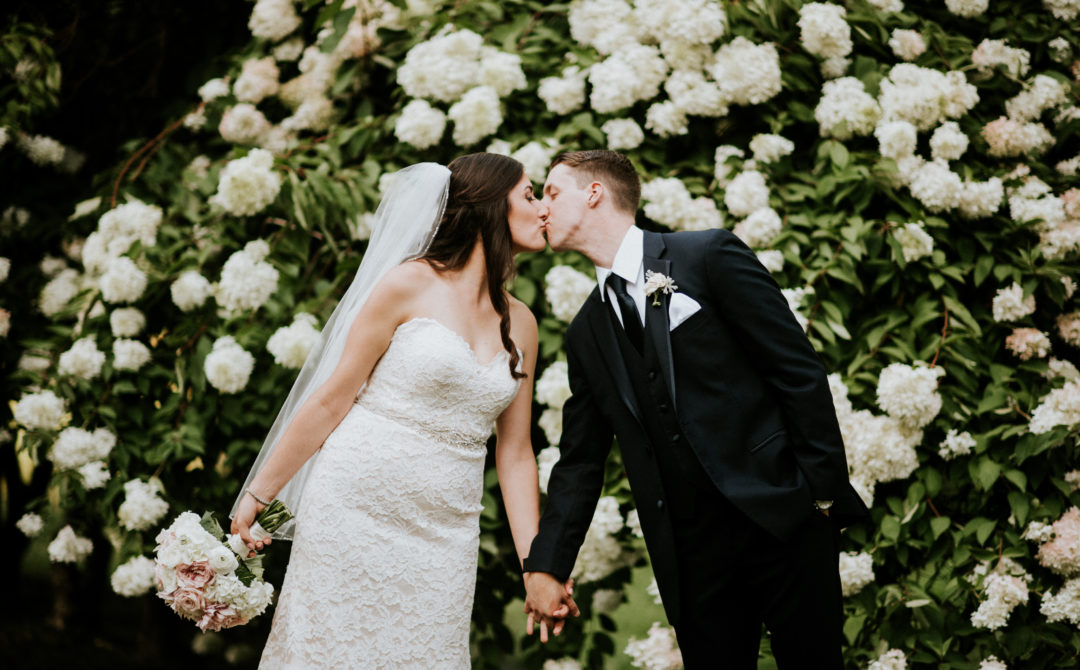 Bride and groom kiss in outdoor wedding ceremony in Boston Massachusetts wedding venue