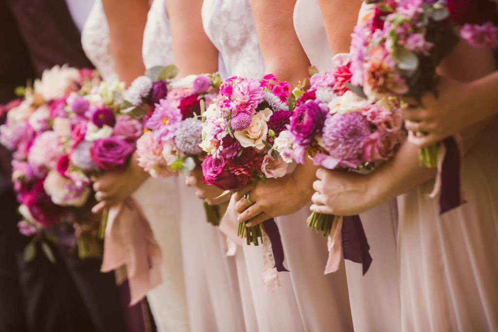 bridesmaids holding bright floral bouquets for outdoor wedding in New England