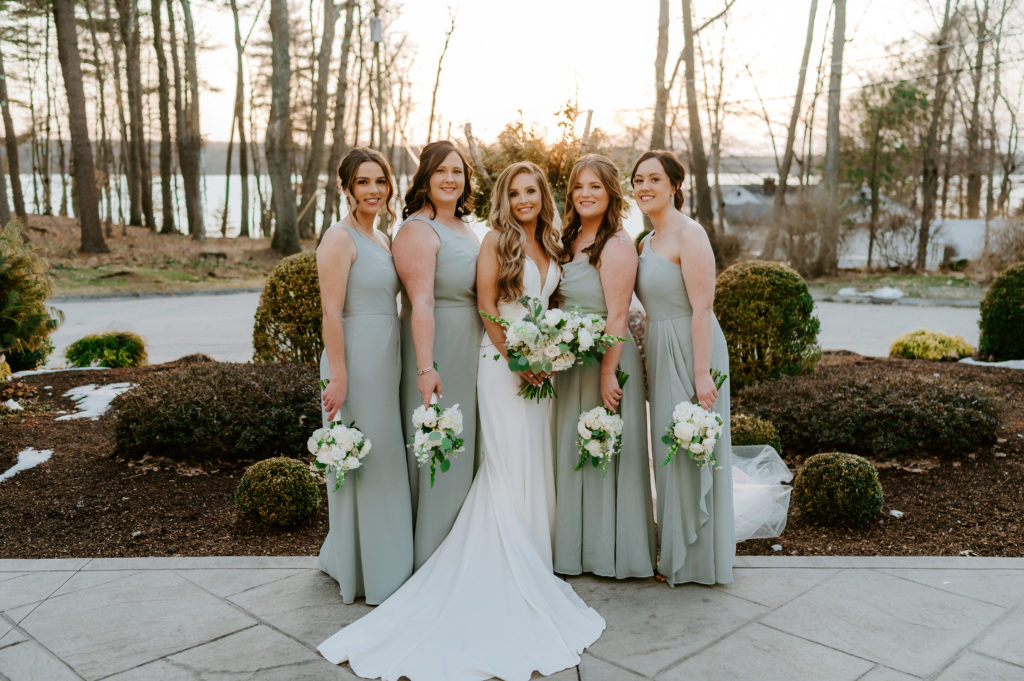Bride and bridesmaids pose outside Saphire Estate in Sharon, Massachusetts