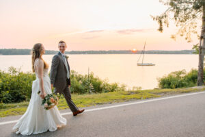 Bride and Groom walking by Lake Massapoag during summer sunset