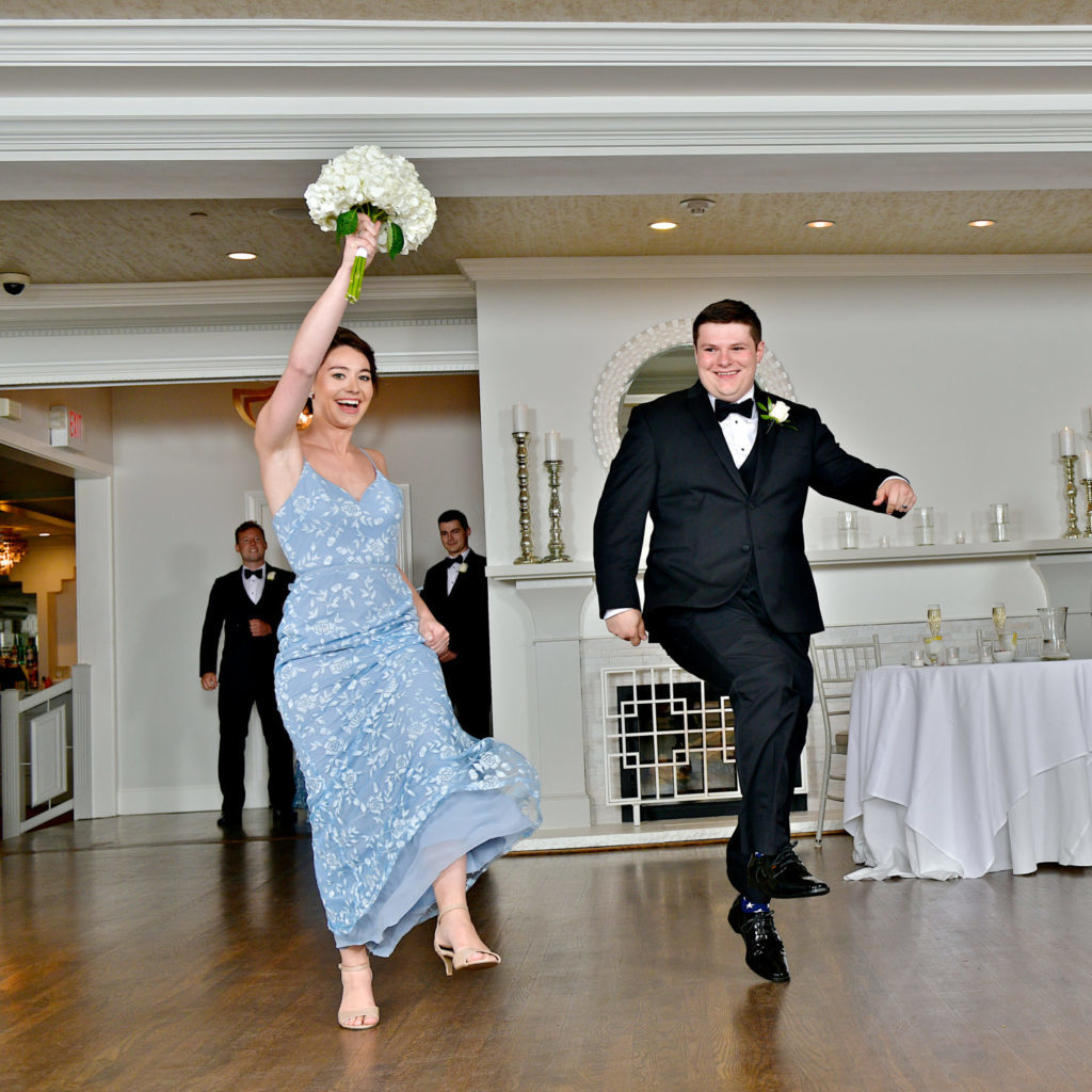 Bridesmaid and groomsman dancing to a wedding reception entrance song