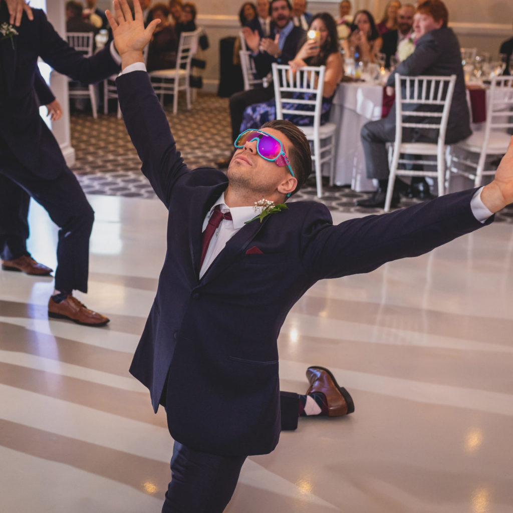 Groomsmen dancing to a wedding reception entrance song