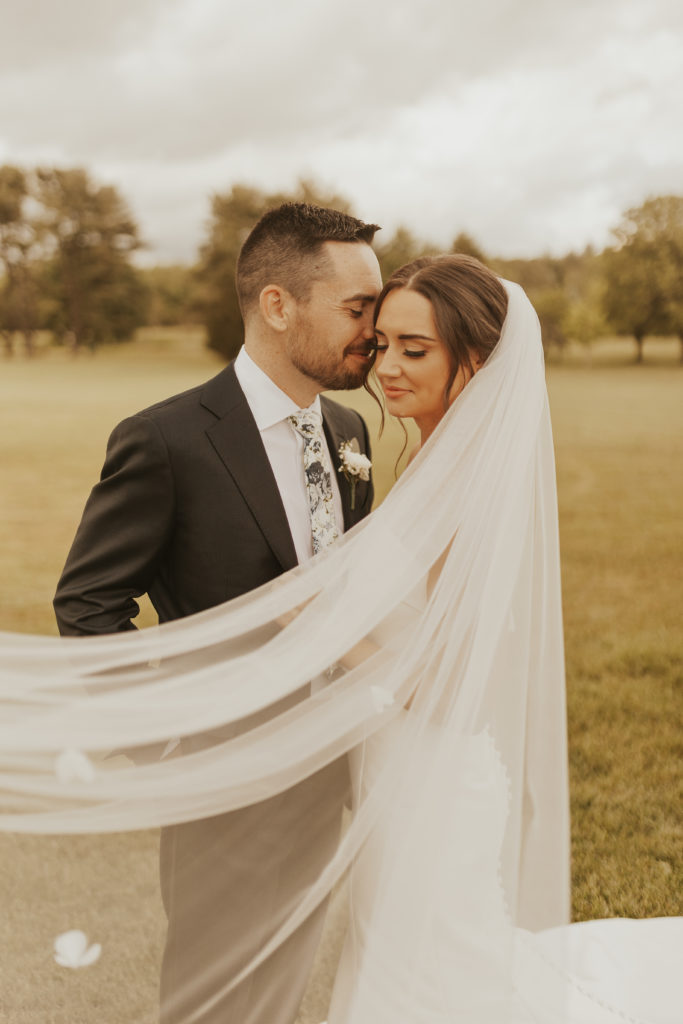 Bride and groom wedding portrait with long veil