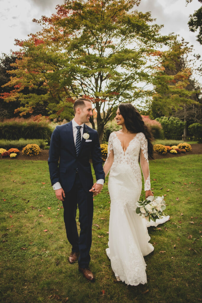 Bride and groom walk beautiful grounds at The Villa in East Bridgewater, Massachusetts