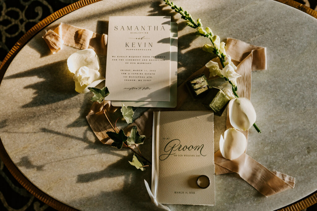 white and greenery wedding invitations and flowers
