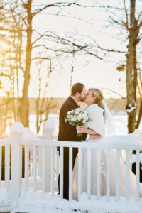 Bride and Groom Kiss on Bridge at Saphire Estate