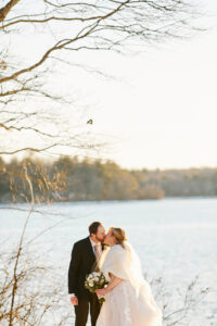 Bride and Groom Take Photos at Lake Massapoag in Sharon Massachusetts