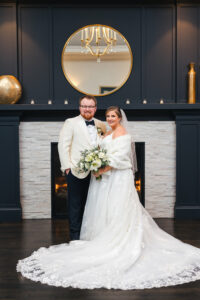 Bride and Groom in front of Fireplace at Saphire Estate
