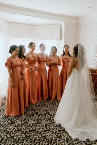 Bride Does First Look With Her Bridesmaids in Bridal Suite at Saphire Estate in Sharon Massachusetts