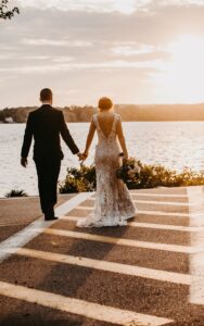Bride and Groom Cross the Street at Sunset