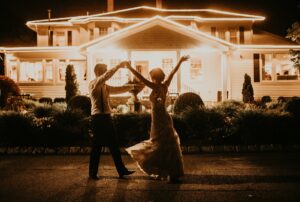 Bride and Groom Dance in Front of Saphire Estate