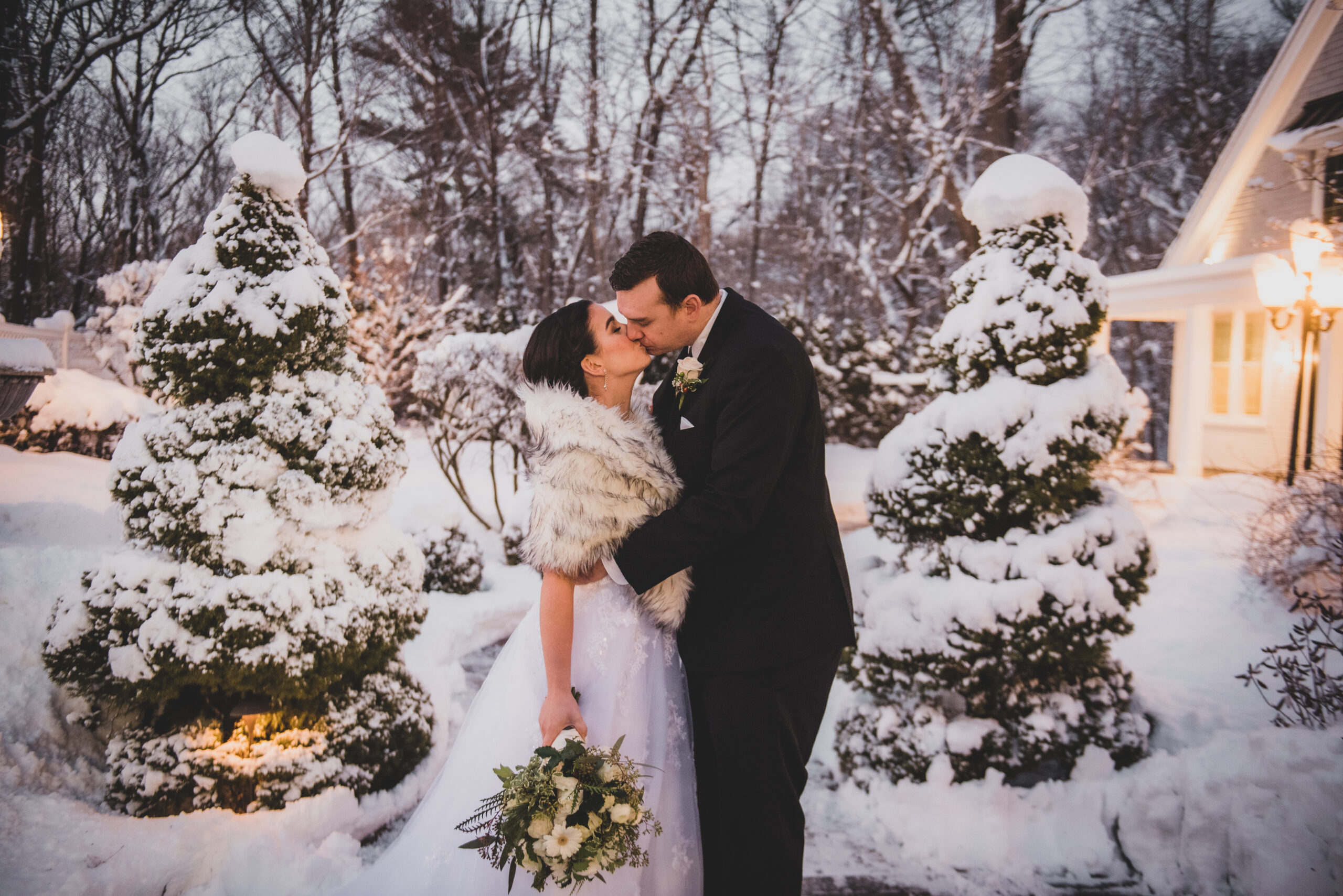 Bride and Groom Kissing at Their Winter Wedding in the Snow