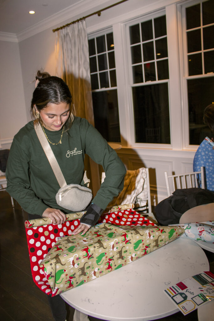 Event Producer Wrapping Gifts for SEG Gives Back