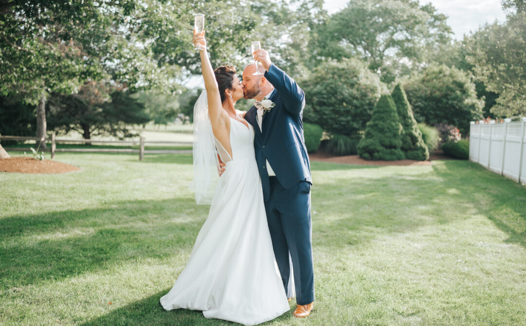 Bride and Groom Toast Champagne Flutes After Getting Married at The Villa in East Bridgewater Massachusetts