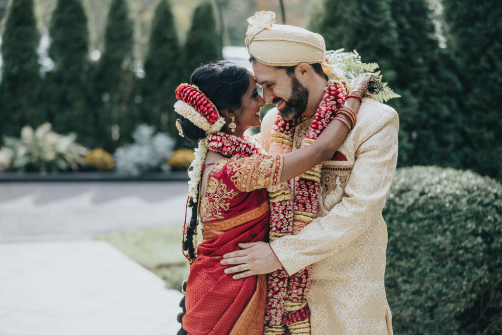 Bride and Groom Wearing Peach Sari and Beige Sherwani Embrace at Avenir in Walpole
