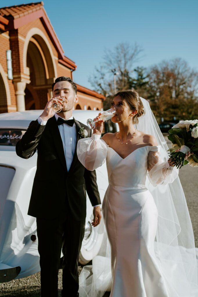 Bride and Groom Drink Champagne After Getting Married at Church in Andover Massachusetts