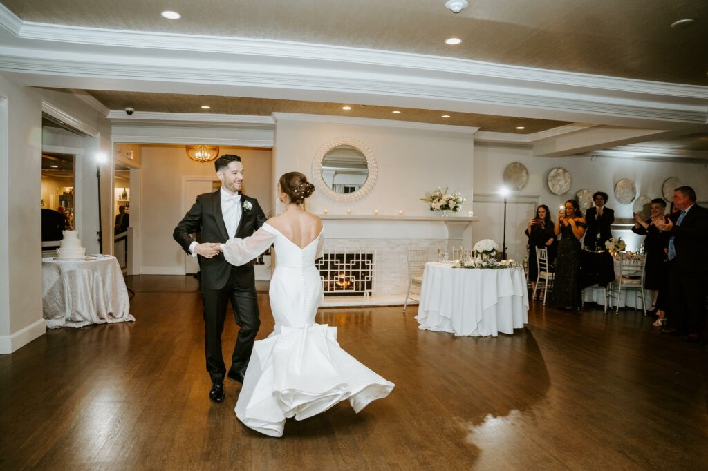 Bride and Groom Smile During First Dance in Ballroom at Saphire Estate in Sharon Massachusetts